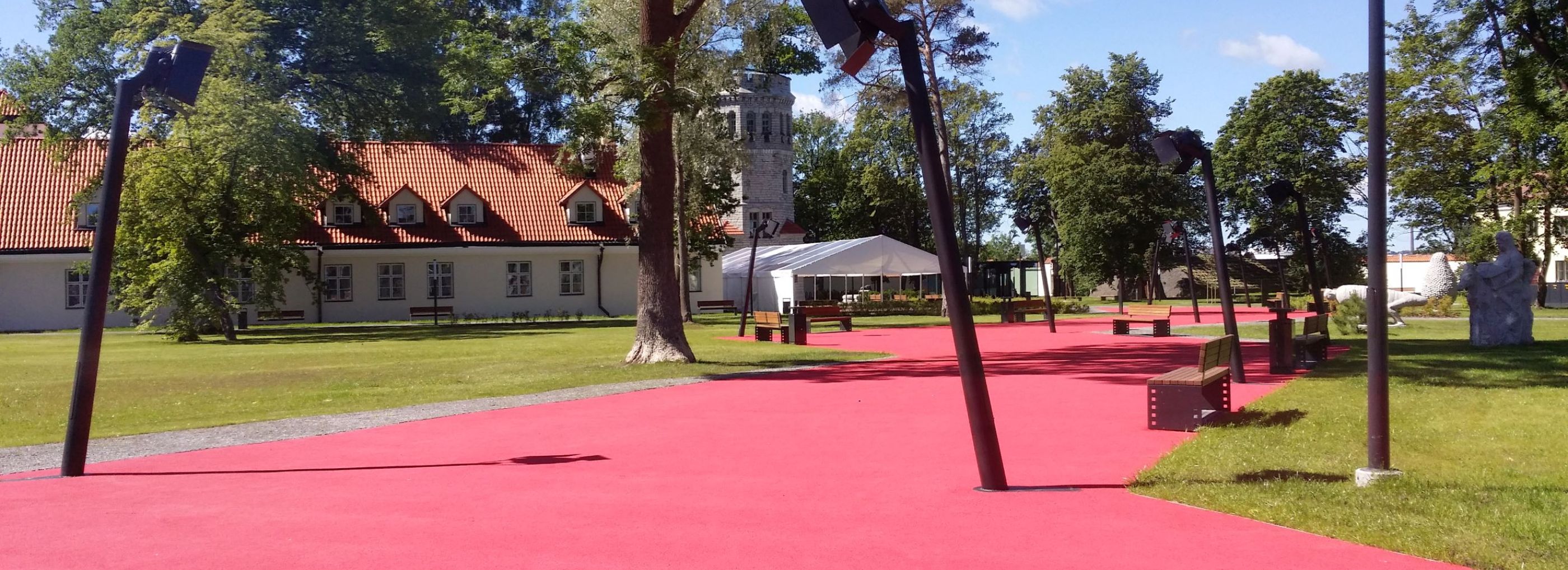 Red walkway path in a park.