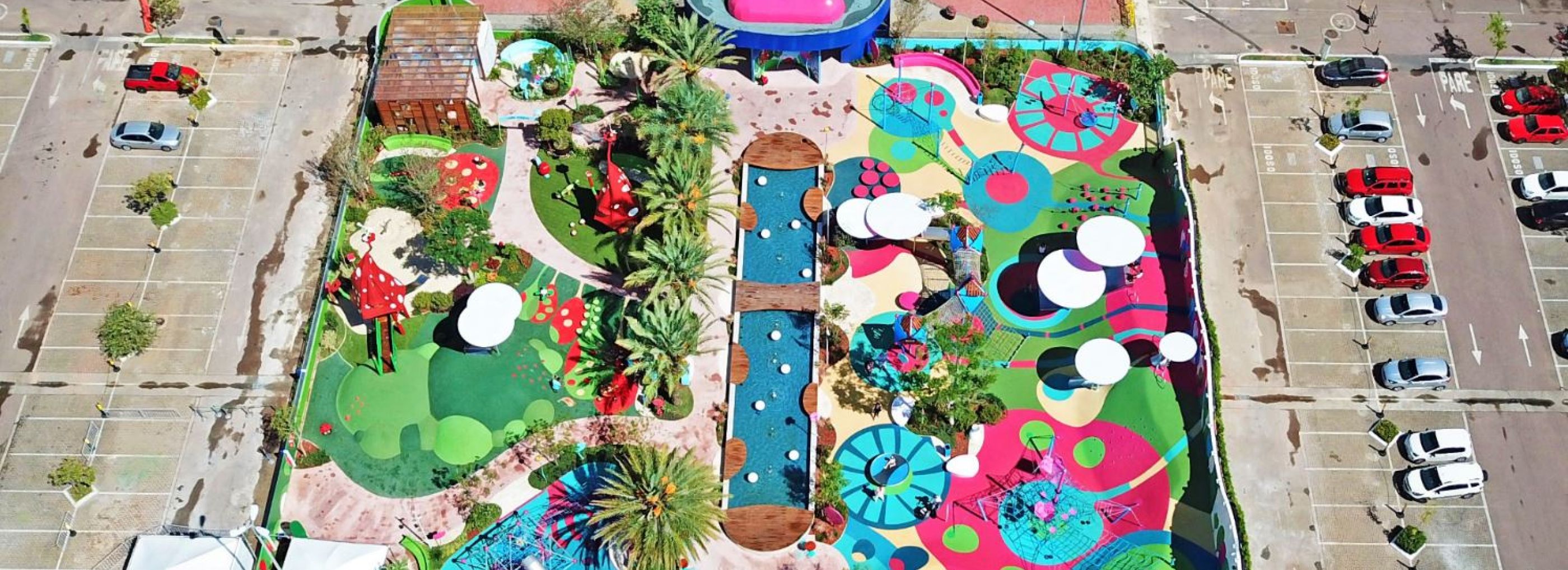 Image of a colourful splash park taken from high above.